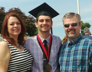 The happy graduate with me and his dad, that cute blonde boy from Freshman Orientation all those years ago.